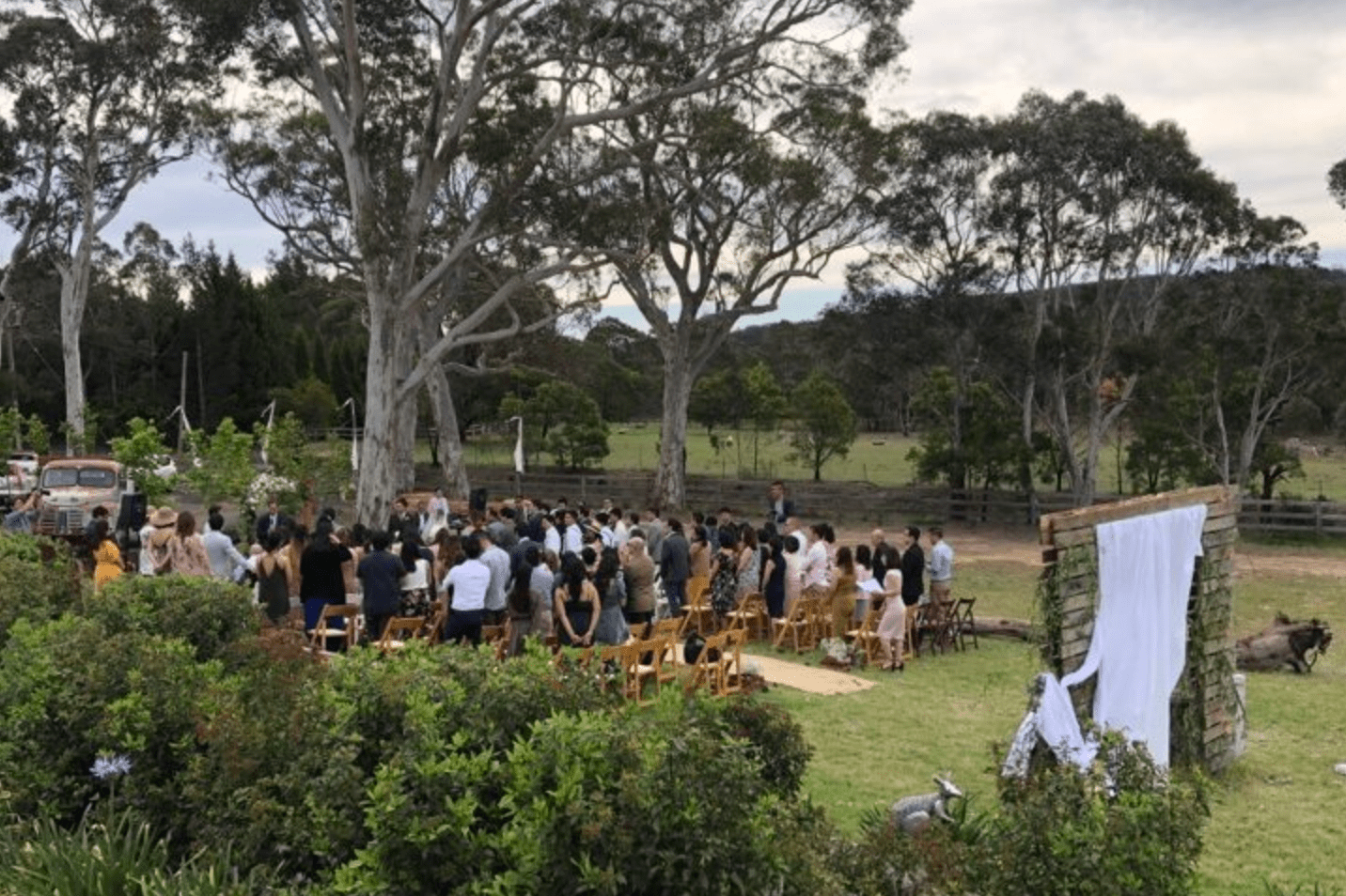 Wedding guests attending a ceremony on the grounds of Berrima Retreat